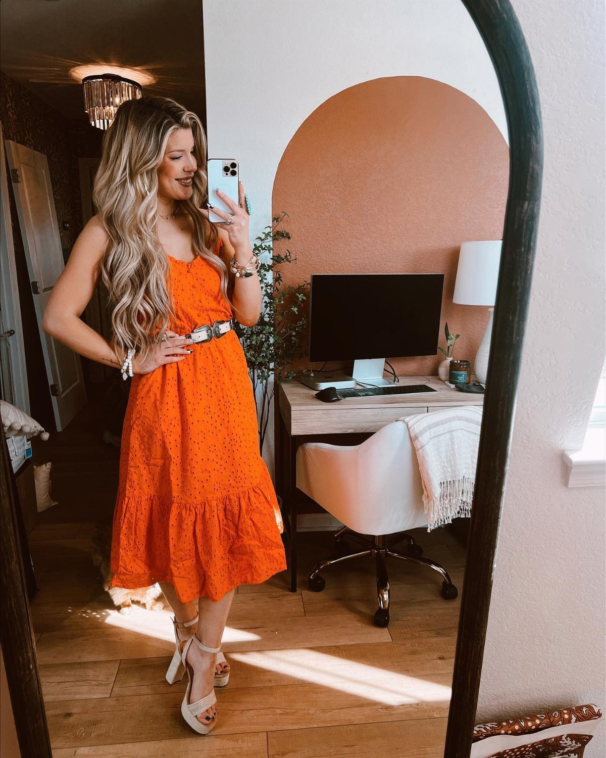 Walmart Spring Outfits: 10 Fresh Ideas for Women This Season 8 Woman in a bright orange tiered midi dress and white wedge sandals taking a selfie.