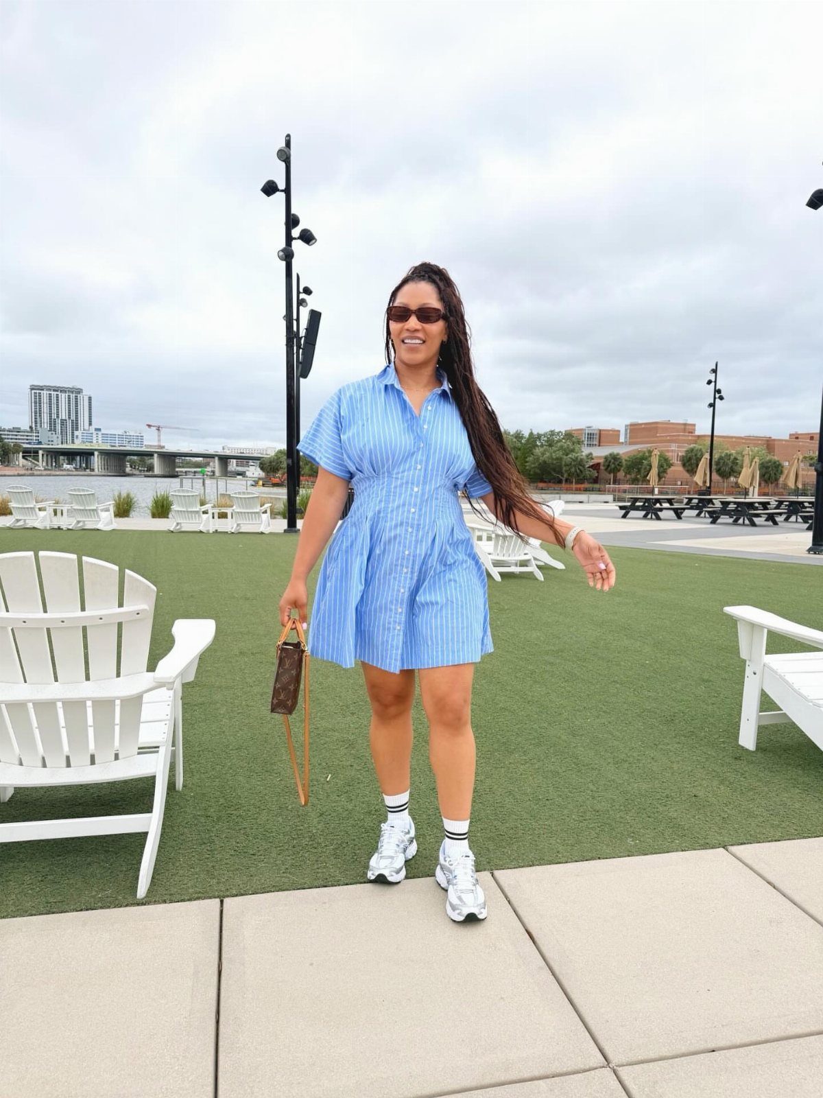 Walmart Spring Outfits: 10 Fresh Ideas for Women This Season 2 Woman wearing a blue and white striped shift dress with white sneakers outdoors.