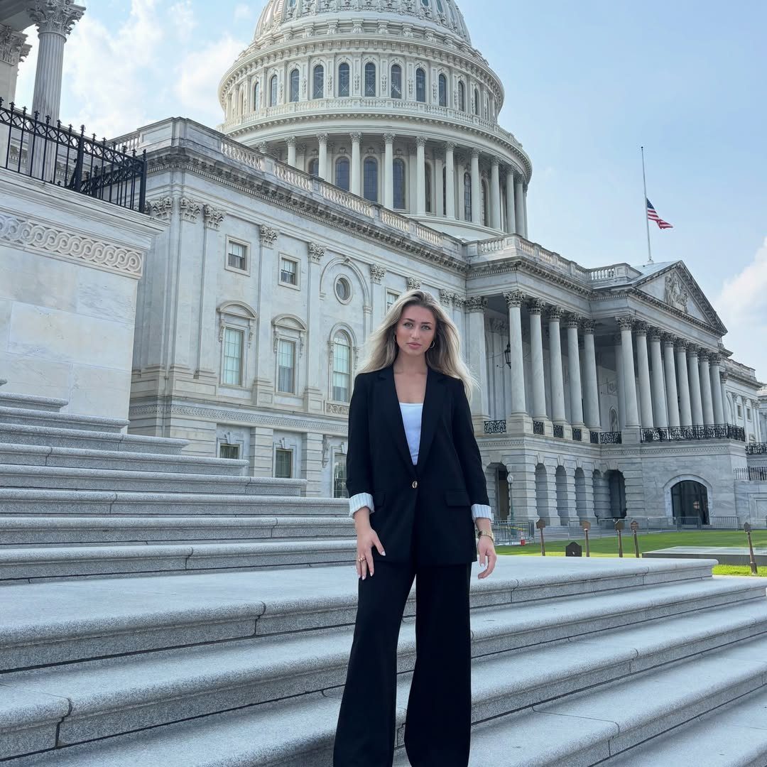 Washington DC Outfits: 11 Stylish Ideas for Your Trip 6 Woman in black blazer and wide leg pants standing before the US Capitol