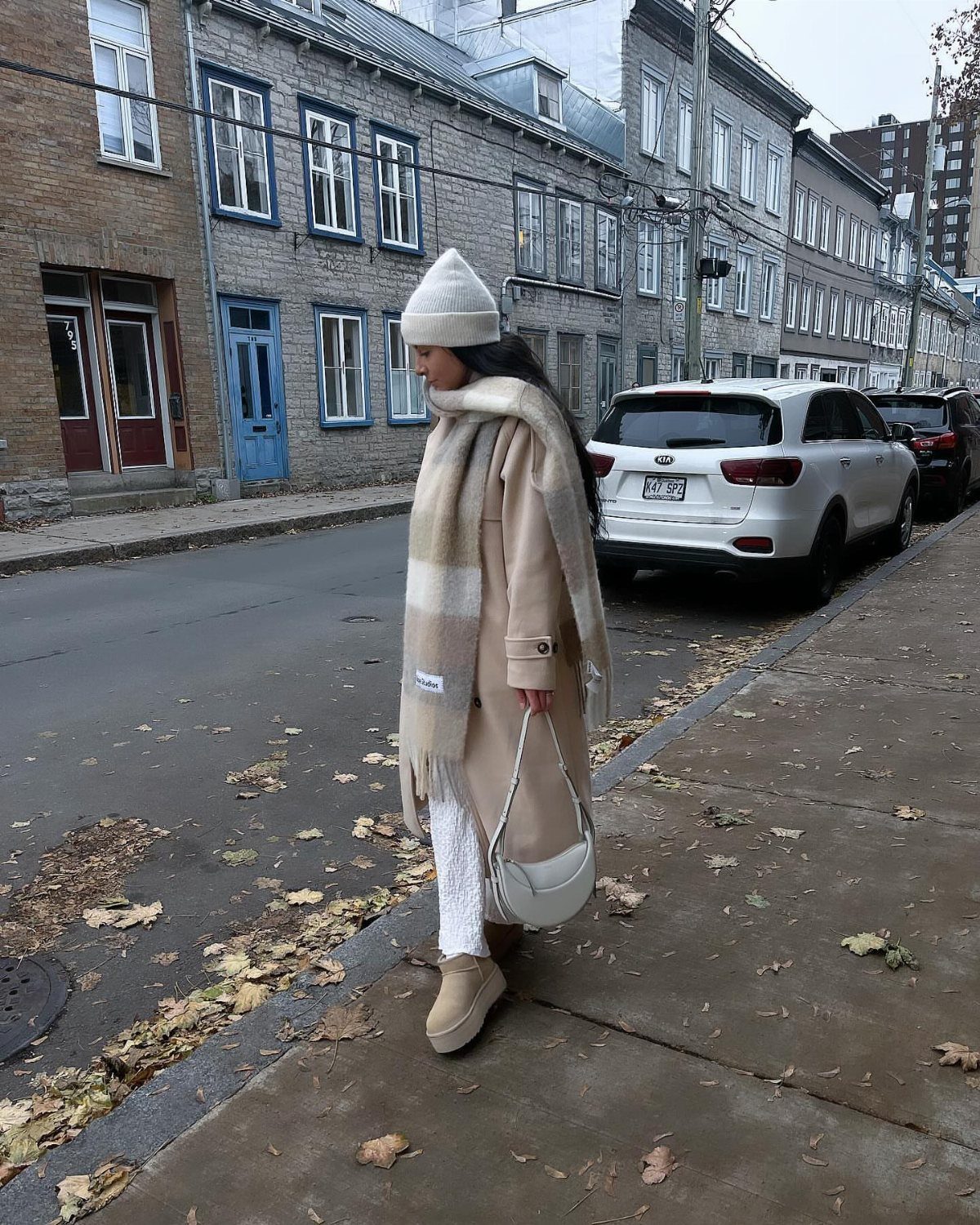 Women's Scarf Coat: 12 Ideas to Try This Season 6 Woman in a beige scarf coat and white beanie walking on a city street