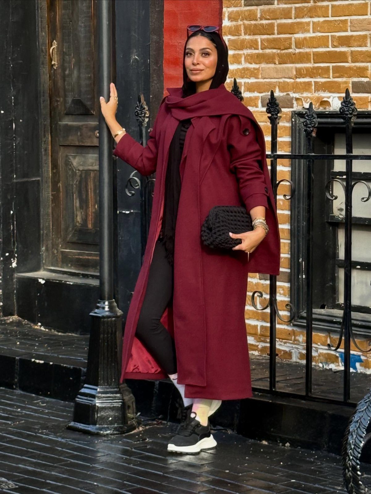 Women's Scarf Coat: 12 Ideas to Try This Season 9 Woman in a long burgundy coat with a matching scarf and black leggings.