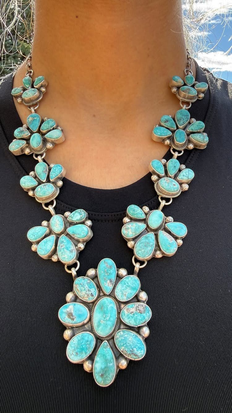 Women's Wild West Outfit Ideas: 9 Styles That Deliver 4 Turquoise necklace with silver petal settings worn over a black shirt